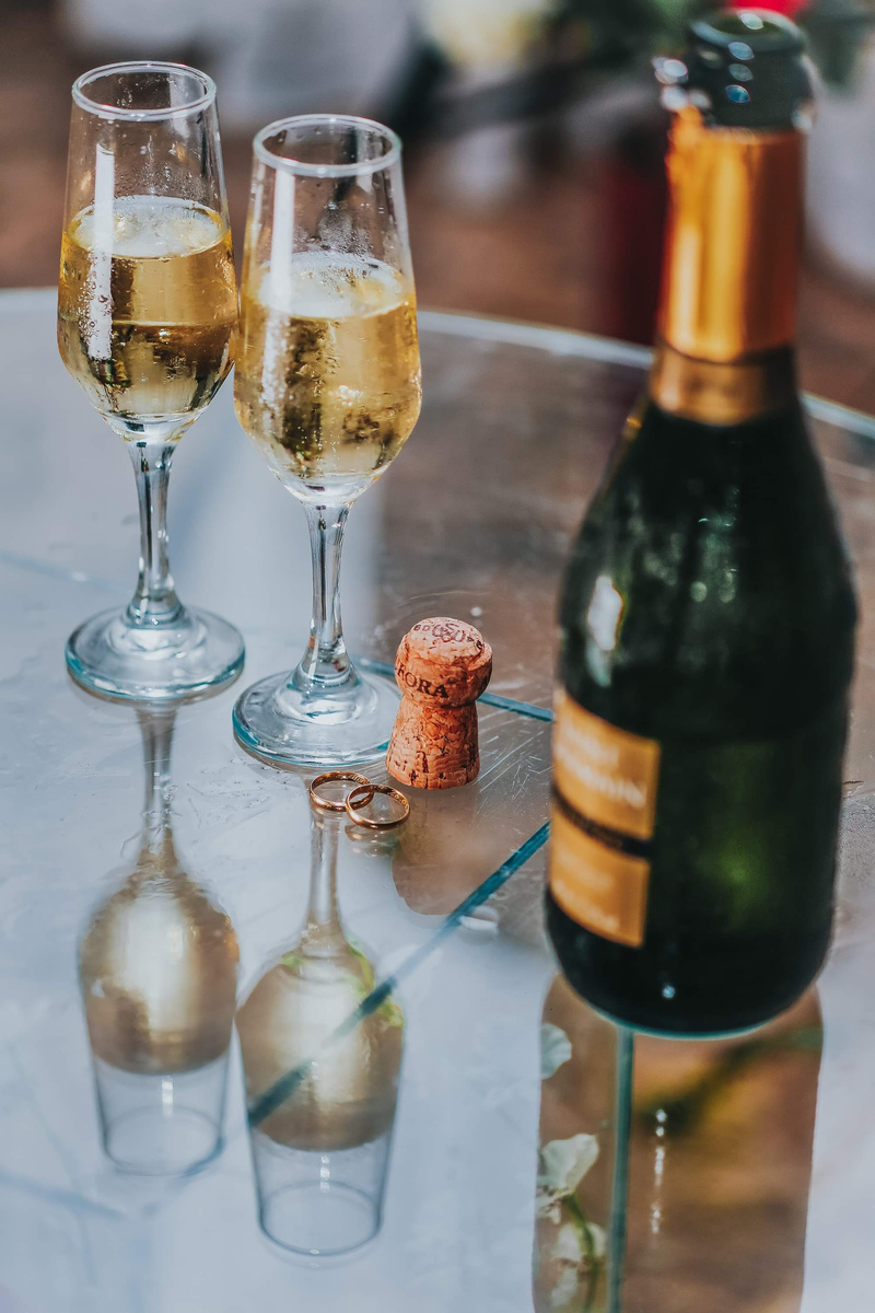 Open Champagne Bottle Near Two Cocktail Glasses