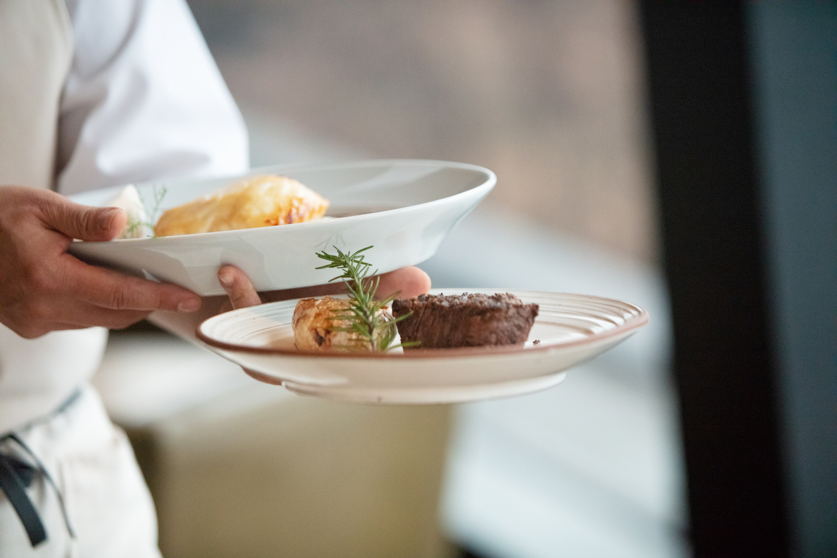 Waiter serving steak